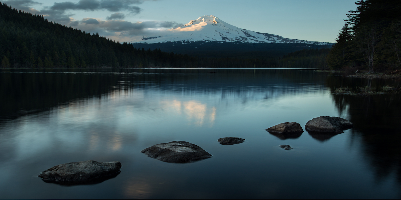 Photo of a lake with a mountain in the background.