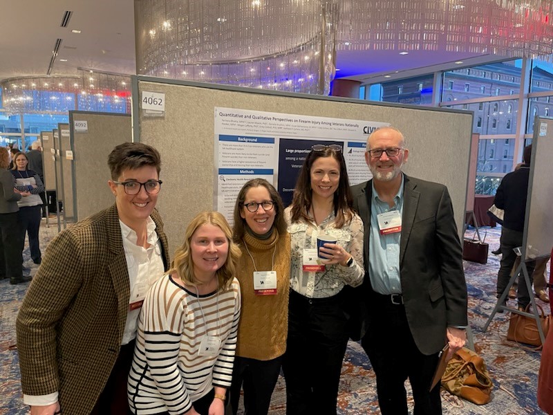 Photo of CIVIC staff with a research poster at the national HSRD meeting